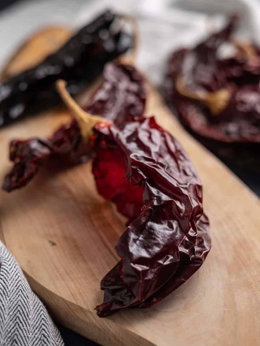 dried chiles on a cutting board