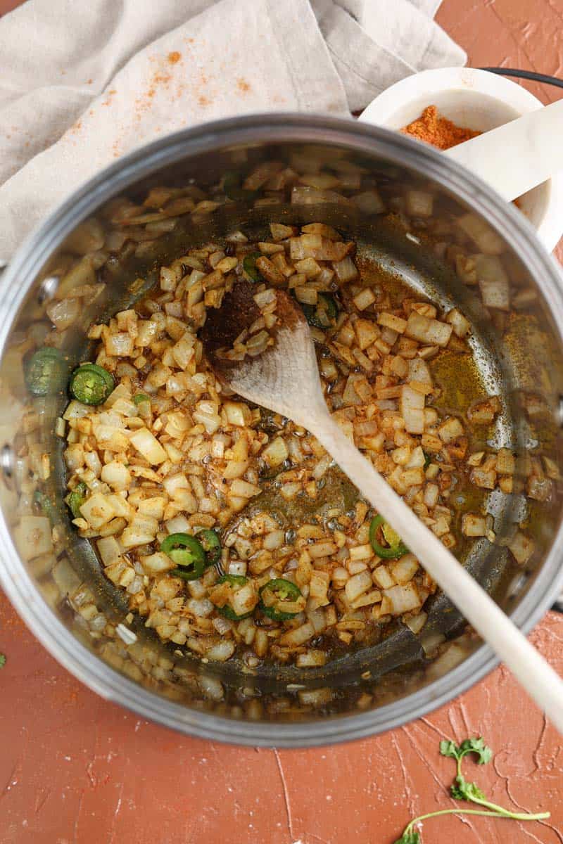 onions, peppers and spices in a pot