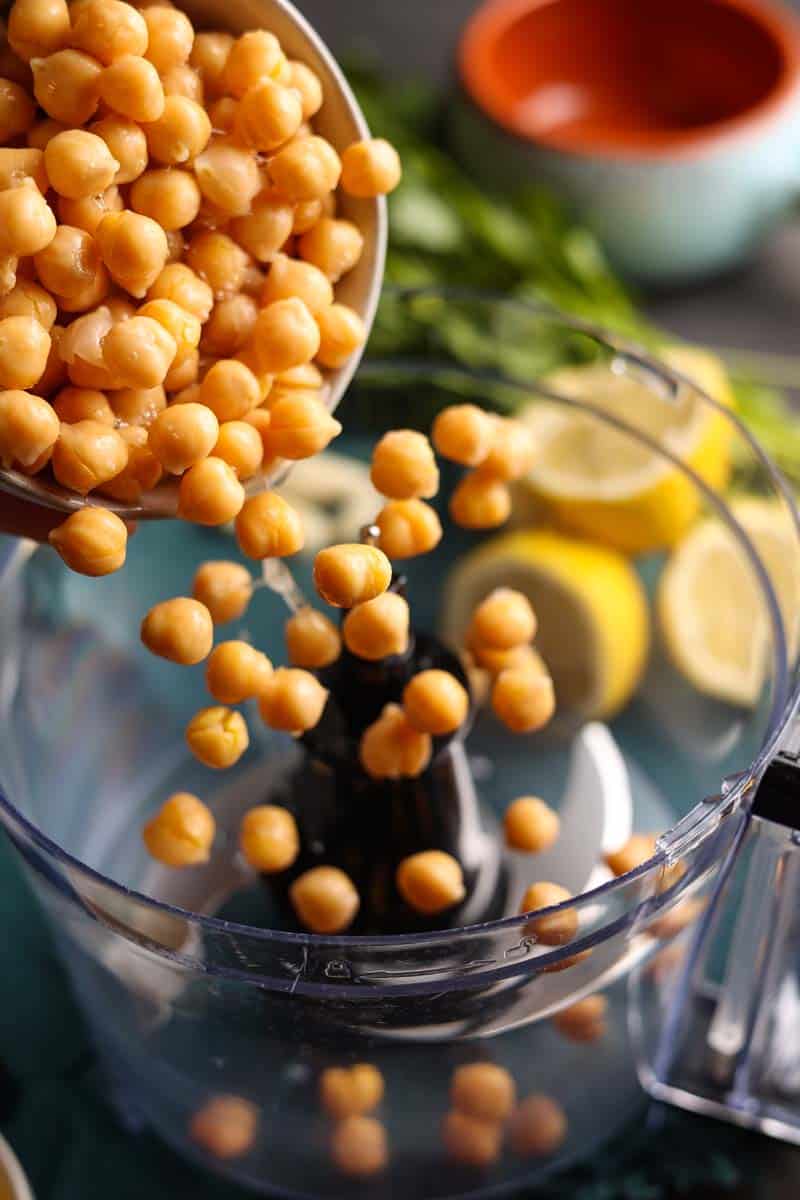 pouring chickpeas into a food processor