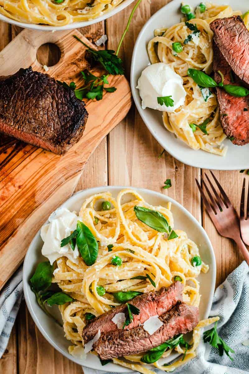 ricotta basil fettuccine and steak on plate