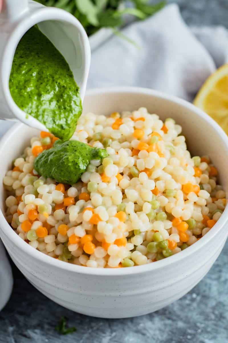 zhoug sauce over couscous in bowl