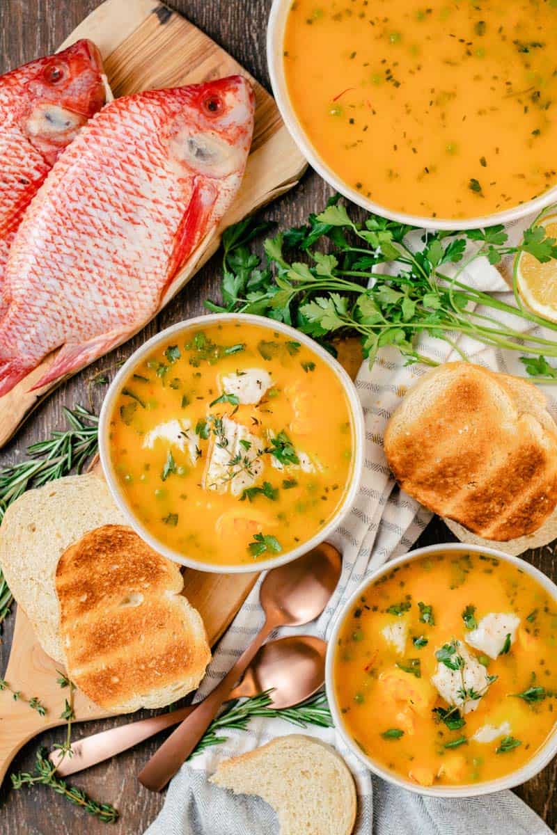 bouillabaisse in bowls and fish in background