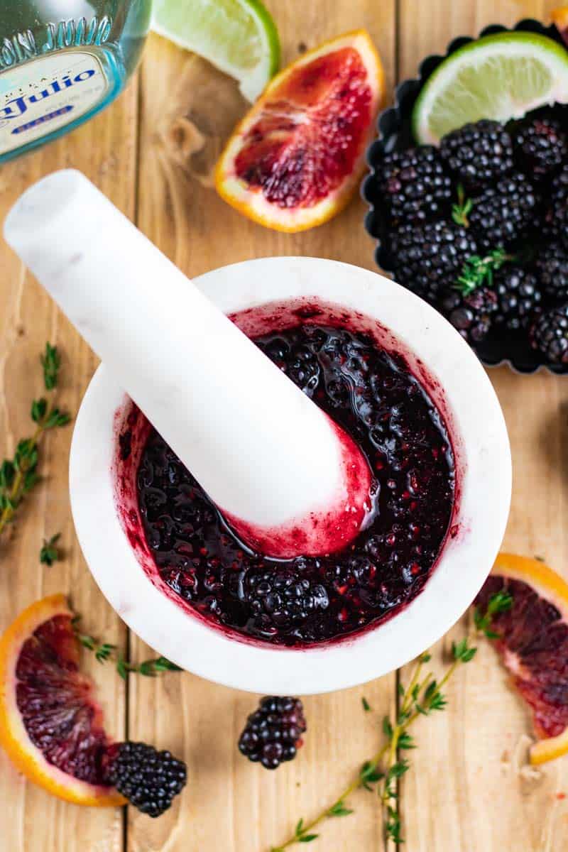 muddled blackberries in mortar