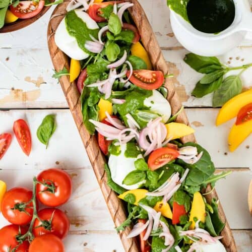 burrata salad on platter with basil vinaigrette