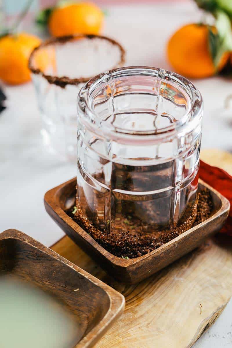 dipping the rim of a cocktail glass into chile salt