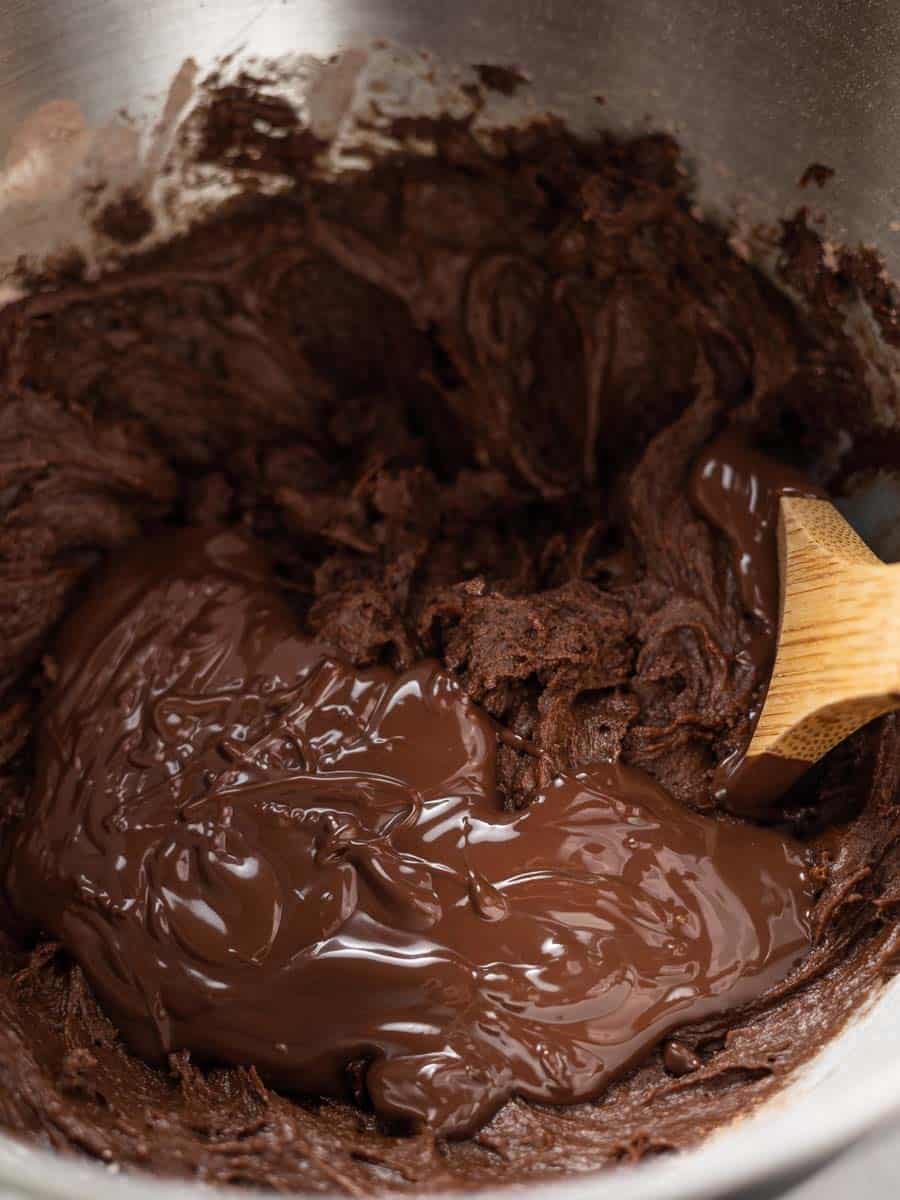 cookie dough and bakers chocolate in a mixing bowl