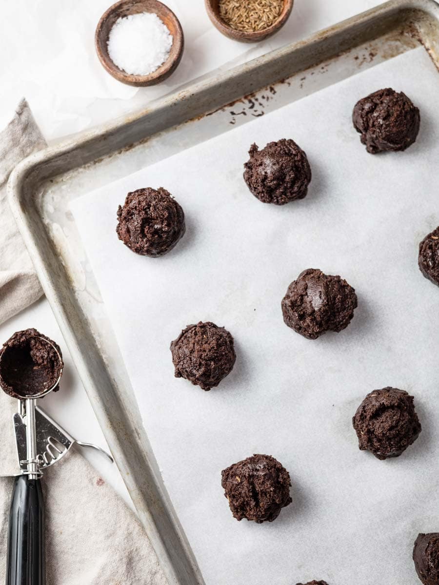 cookie dough balls on a baking sheet