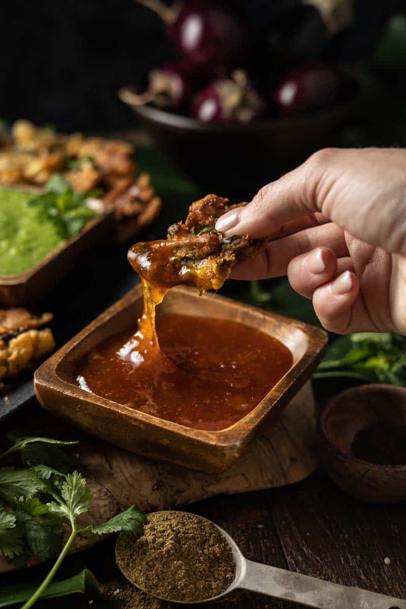 vegetable pakora dipped into mango chutney