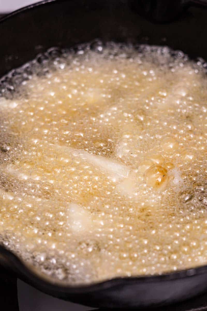 frying yuca fries in hot oil