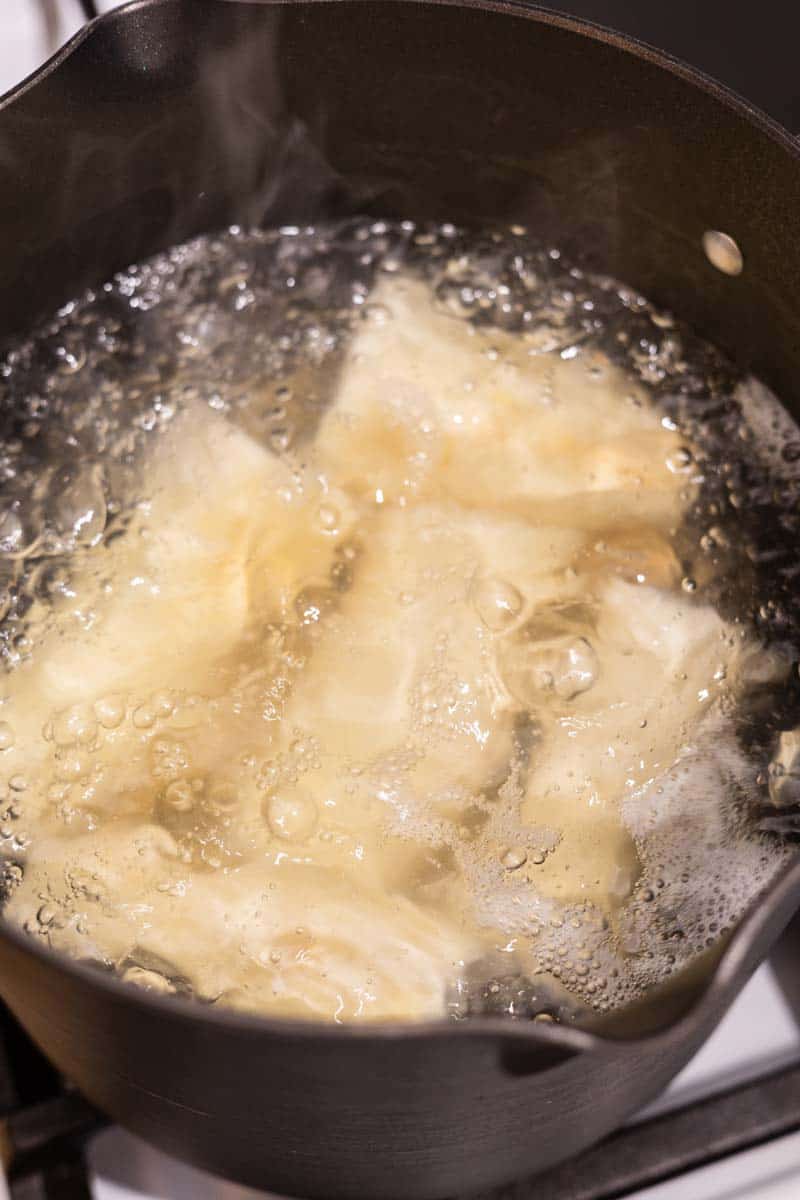 boiling yuca in a pot