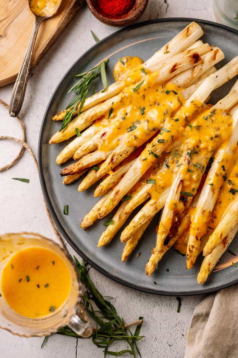 grilled white asparagus with bearnaise sauce on a plate