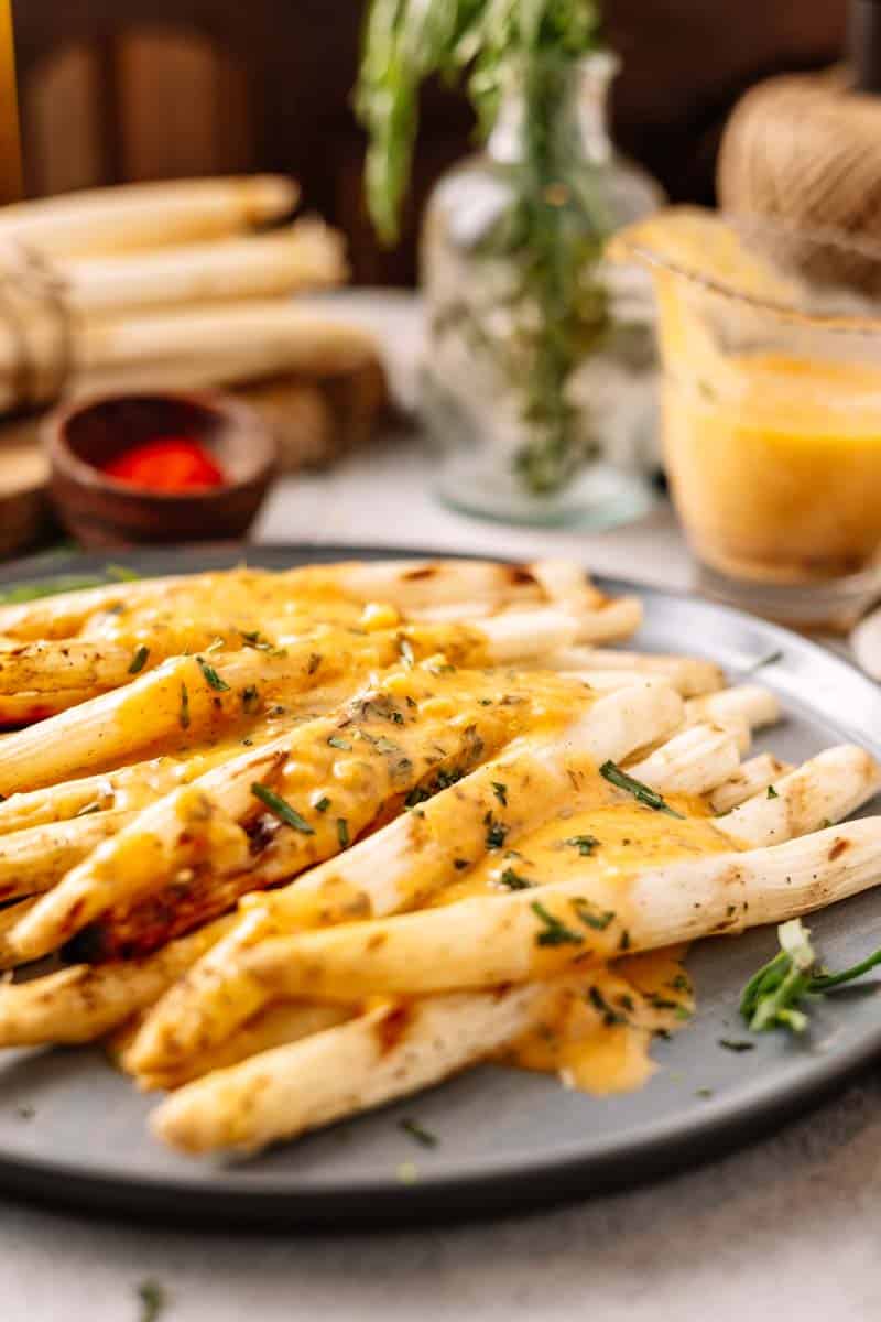 grilled white asparagus with bearnaise sauce on a plate
