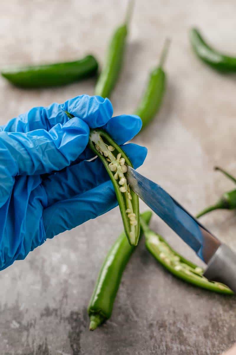 serrano peppers in gloved hand