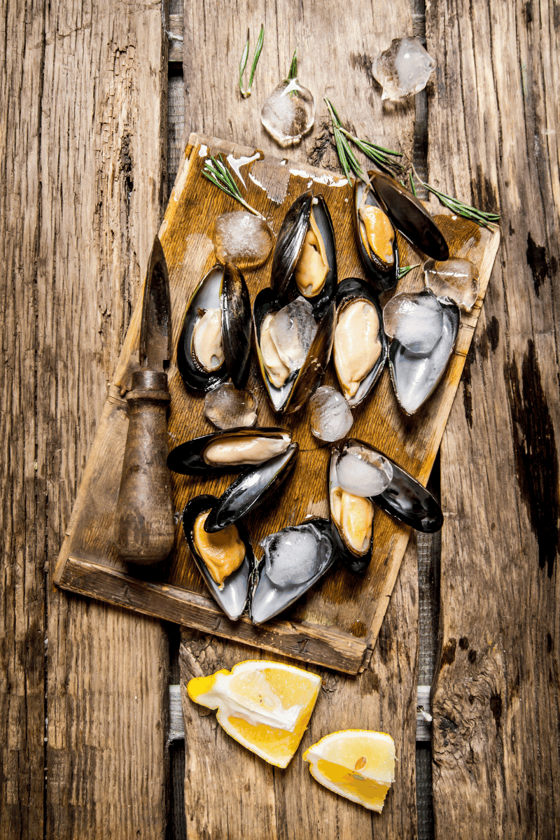 Clams on a wooden surface.