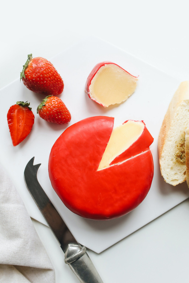 whole gouda on a cutting board.