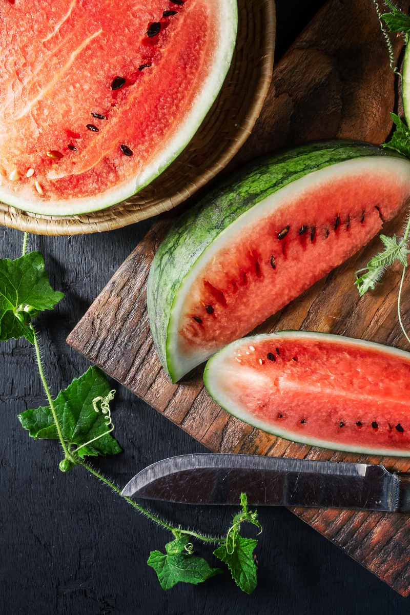 sliced watermelon on a cutting board.