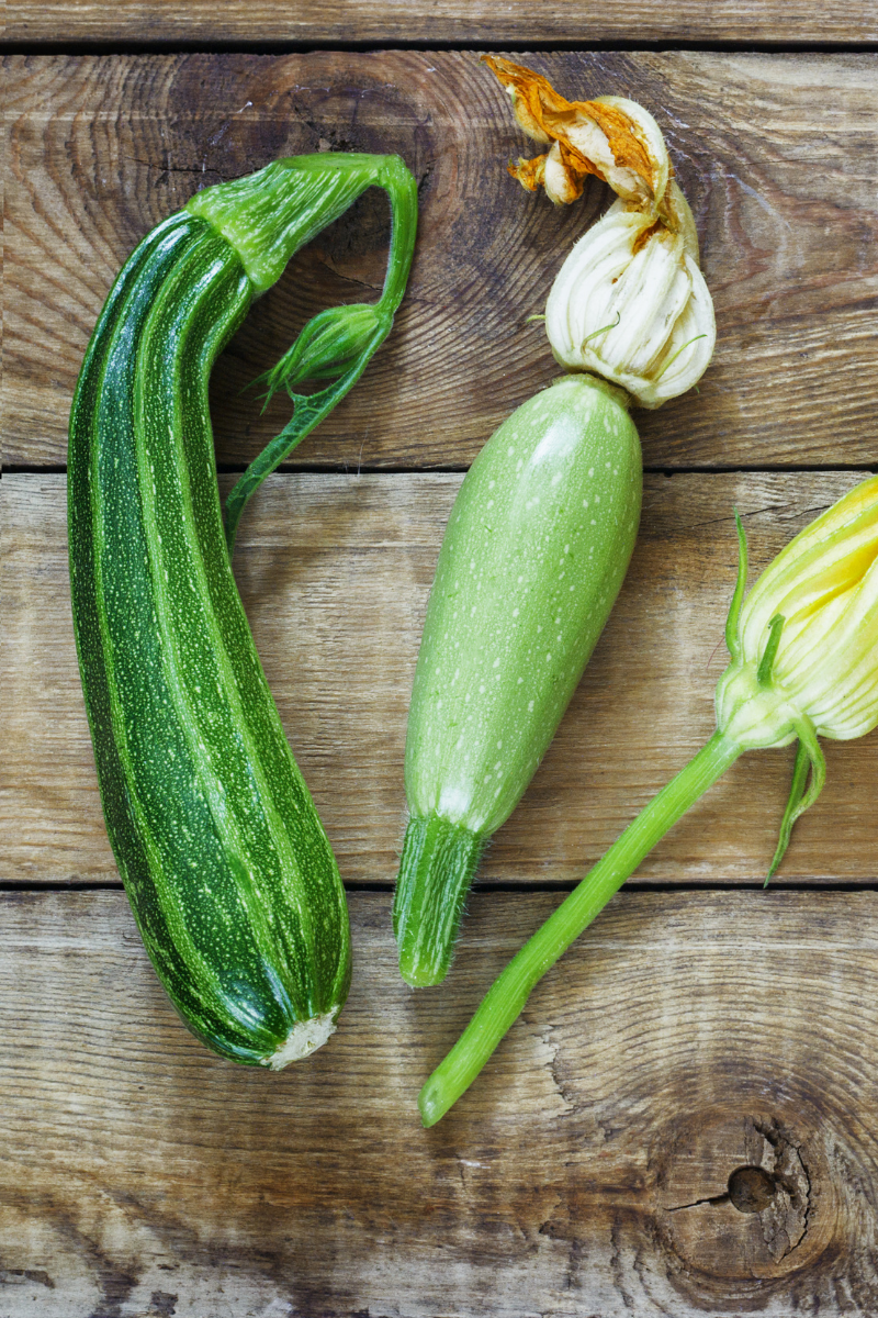 assorted zucchini on a wooden surface.