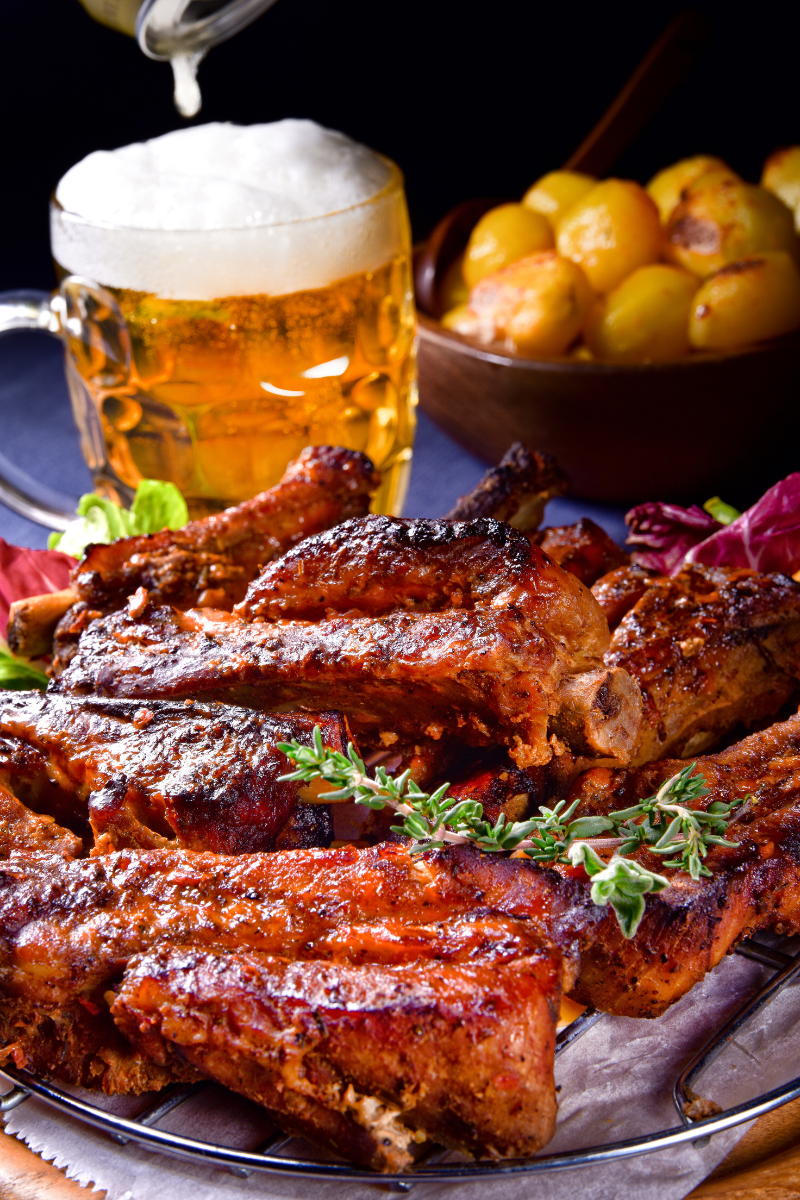 Meat smoked in a BBQ smoker and served with beer.