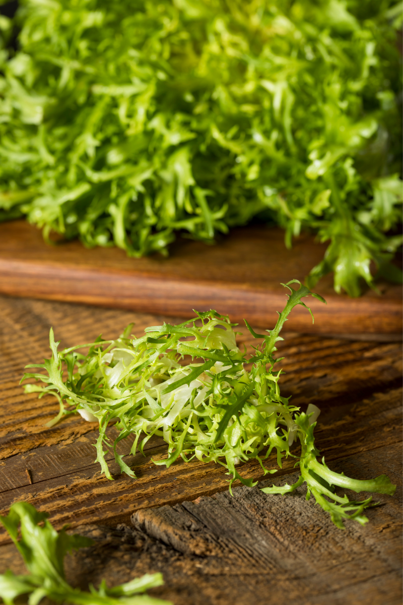 Frisee on a cutting board.