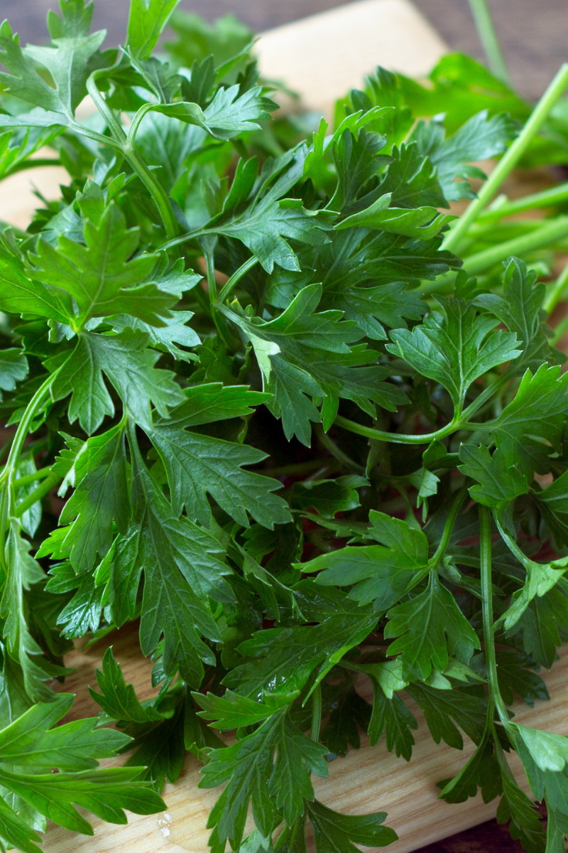 fresh parsley chopped on a cutting board.